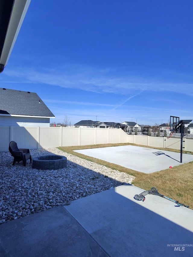 view of yard with an outdoor fire pit, a patio, and a fenced backyard
