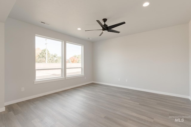 unfurnished room featuring a ceiling fan, recessed lighting, baseboards, and wood finished floors