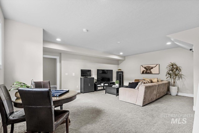 living area featuring light carpet, recessed lighting, a textured ceiling, and baseboards