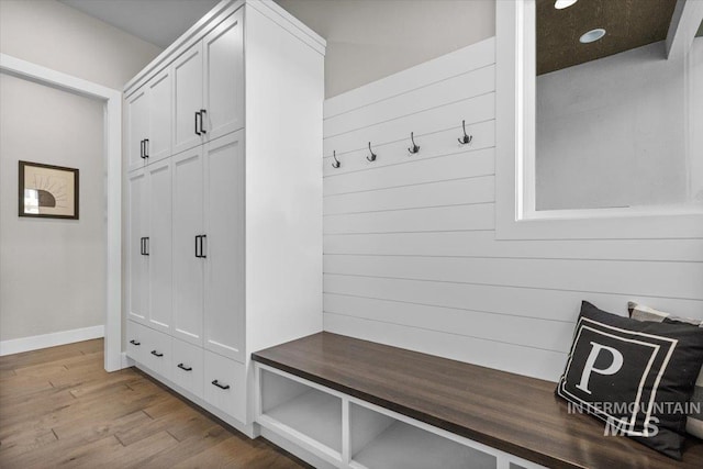 mudroom featuring baseboards and wood finished floors