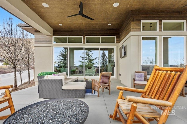 view of patio with outdoor lounge area and a ceiling fan