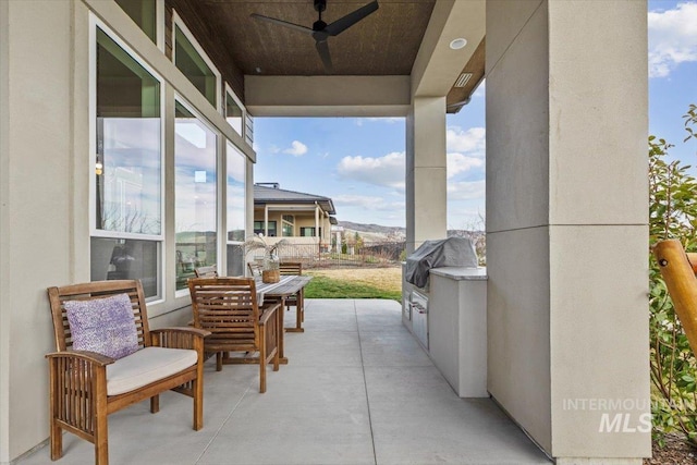 view of patio / terrace featuring an outdoor kitchen, a ceiling fan, and grilling area