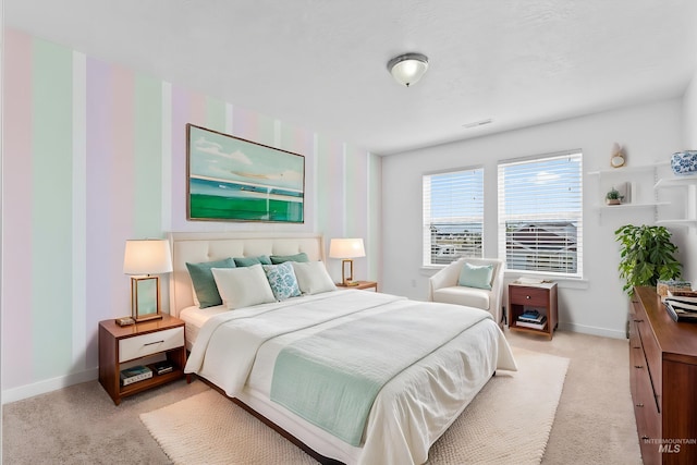 bedroom featuring light colored carpet and baseboards