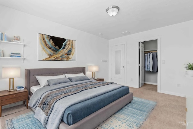 bedroom with baseboards, a walk in closet, and carpet