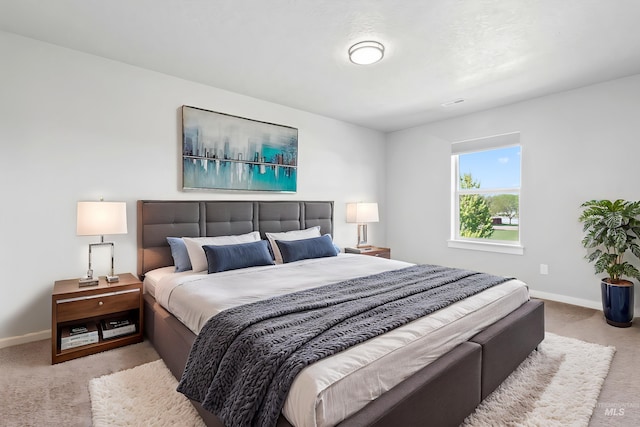 carpeted bedroom featuring baseboards
