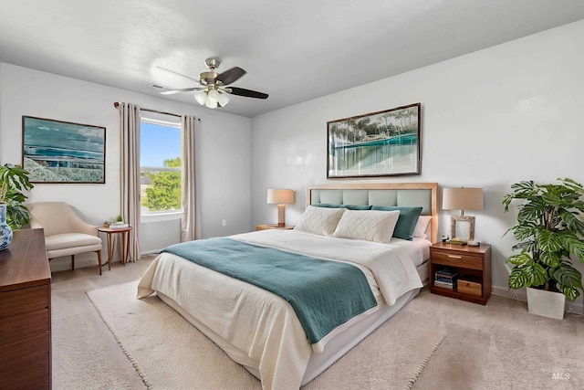 carpeted bedroom featuring baseboards and ceiling fan