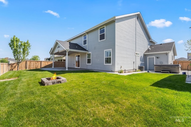 back of property with a hot tub, central AC, a fenced backyard, a patio, and a fire pit