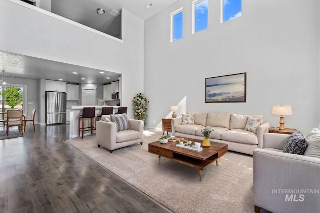 living room featuring a high ceiling and light wood finished floors