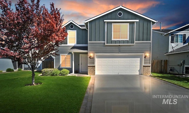 traditional-style house featuring board and batten siding, brick siding, a garage, and driveway