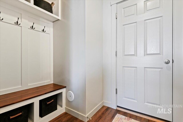 mudroom featuring dark wood-style floors and baseboards
