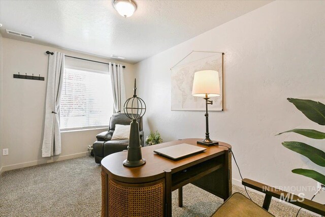 carpeted office space with baseboards