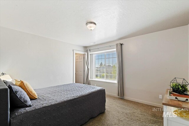 bedroom with light carpet and baseboards