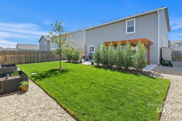 back of property featuring a patio and a vegetable garden