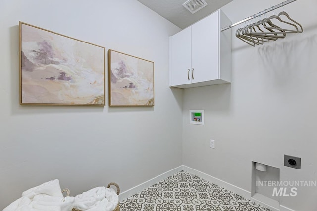 laundry area with visible vents, baseboards, electric dryer hookup, cabinet space, and washer hookup
