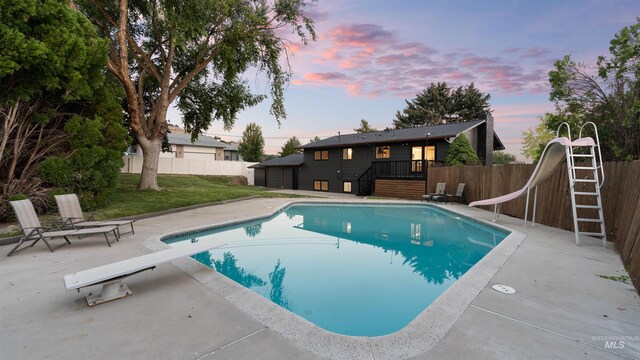 view of front of home with a garage and a yard