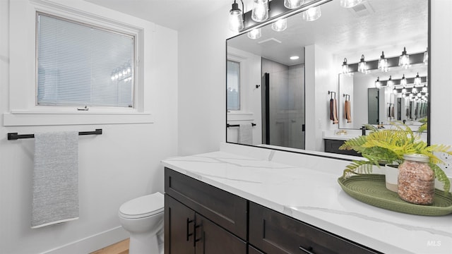 full bathroom with toilet, a stall shower, visible vents, and vanity