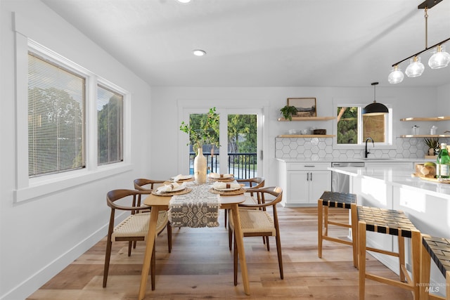 dining space featuring baseboards, recessed lighting, and light wood-style floors