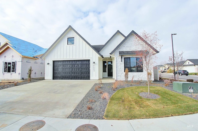 4658 S Hennessy Ave, Meridian, ID 83642 - view of front facade with board and batten siding, a front lawn, and driveway