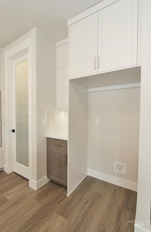 4658 S Hennessy Ave, Meridian, ID 83642 - kitchen featuring wood finished floors, white cabinets, and baseboards