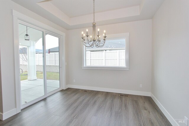 4658 S Hennessy Ave, Meridian, ID 83642 - unfurnished dining area featuring a wealth of natural light, wood finished floors, and a notable chandelier