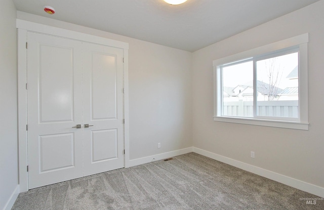 4658 S Hennessy Ave, Meridian, ID 83642 - unfurnished bedroom featuring baseboards, light carpet, and a closet