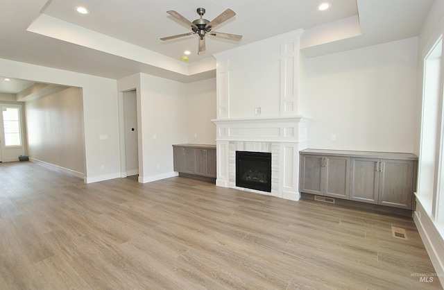 4658 S Hennessy Ave, Meridian, ID 83642 - unfurnished living room with visible vents, a ceiling fan, and a tray ceiling