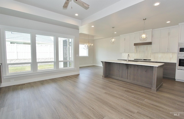 4658 S Hennessy Ave, Meridian, ID 83642 - kitchen featuring light countertops, baseboards, oven, gas cooktop, and backsplash