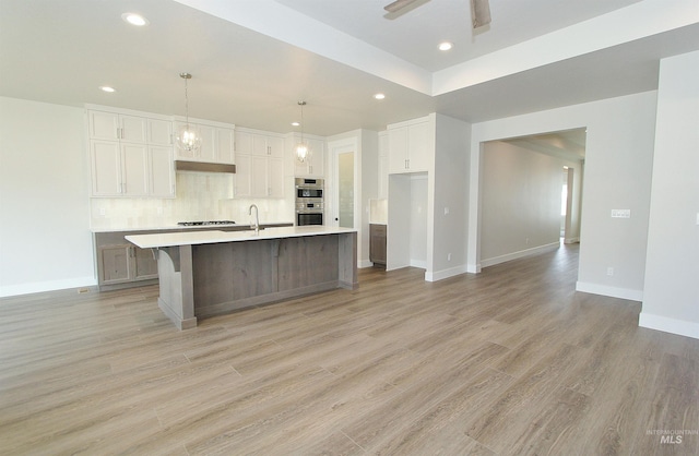 4658 S Hennessy Ave, Meridian, ID 83642 - kitchen featuring tasteful backsplash, light countertops, white cabinets, and recessed lighting