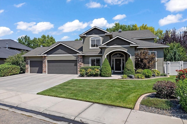 craftsman house with a front yard and a garage