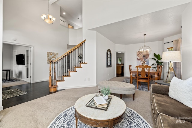 living room featuring a notable chandelier and carpet floors