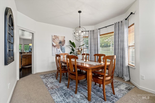 carpeted dining room with an inviting chandelier