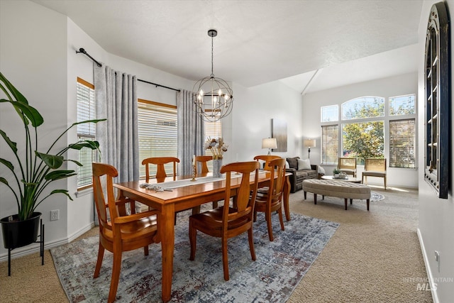 carpeted dining room featuring an inviting chandelier