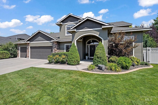 view of front of home featuring a garage and a front yard