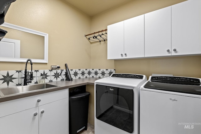 washroom featuring cabinets, separate washer and dryer, and sink