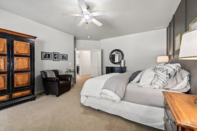 bedroom with ceiling fan and light carpet