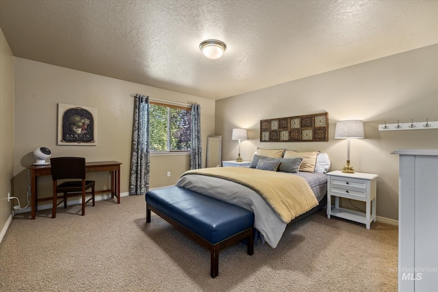 bedroom featuring carpet flooring and a textured ceiling