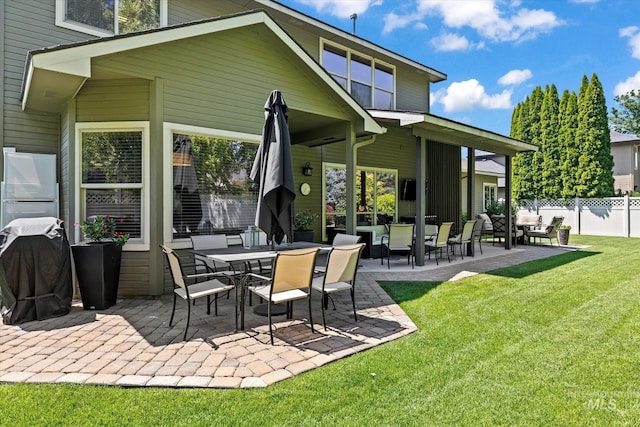 back of house featuring a patio area and a yard