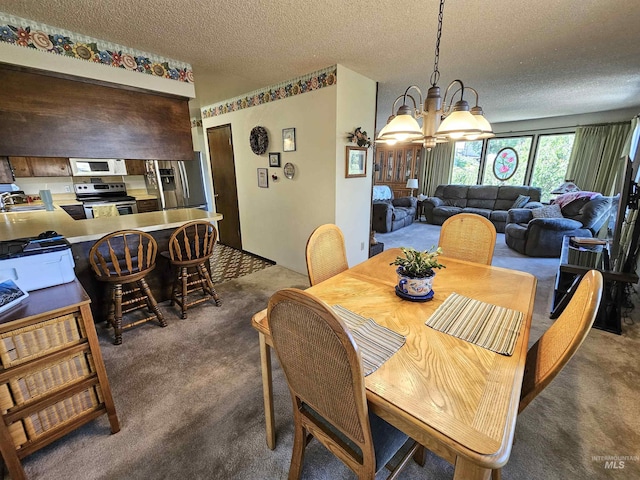 409 Garfield St, Asotin, WA 99402 - dining area featuring carpet, a chandelier, and a textured ceiling