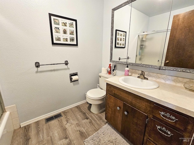 409 Garfield St, Asotin, WA 99402 - full bath featuring an enclosed shower, vanity, and wood finished floors