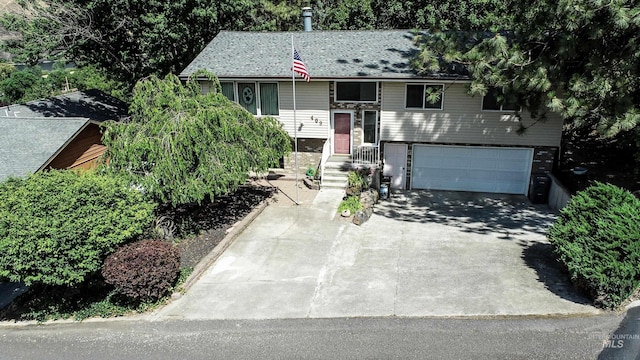 409 Garfield St, Asotin, WA 99402 - raised ranch with concrete driveway, a garage, and brick siding