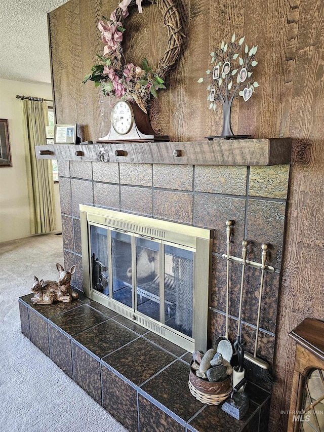 409 Garfield St, Asotin, WA 99402 - detailed view of a tile fireplace, carpet flooring, and a textured ceiling
