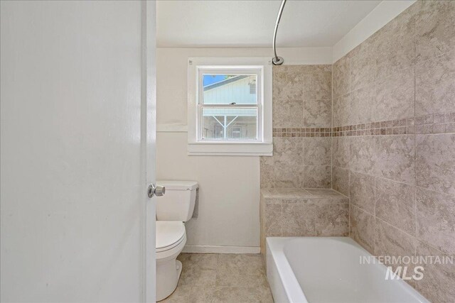 1324 E Oak St, Caldwell, ID 83605 - full bathroom featuring a bath, toilet, baseboards, and tile patterned flooring