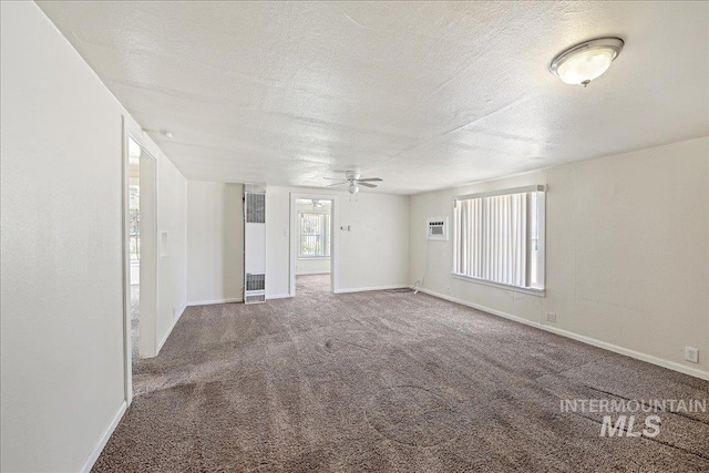 1324 E Oak St, Caldwell, ID 83605 - unfurnished room with a heating unit, carpet, a textured ceiling, baseboards, and a ceiling fan
