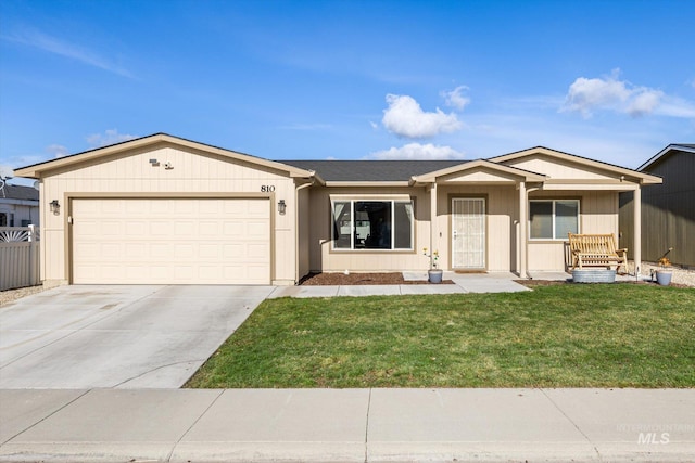 ranch-style house featuring a front yard, covered porch, and a garage