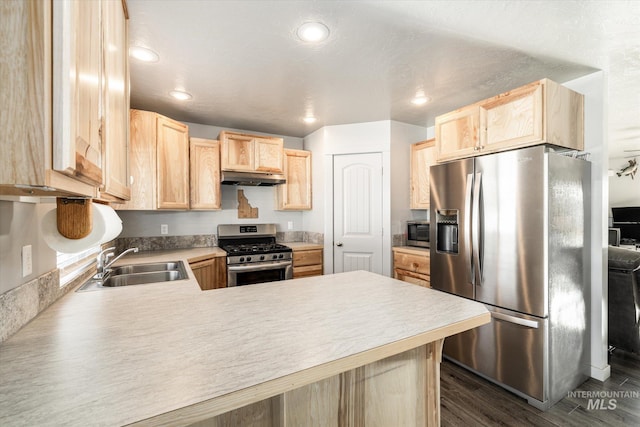 kitchen featuring appliances with stainless steel finishes, sink, kitchen peninsula, and light brown cabinets