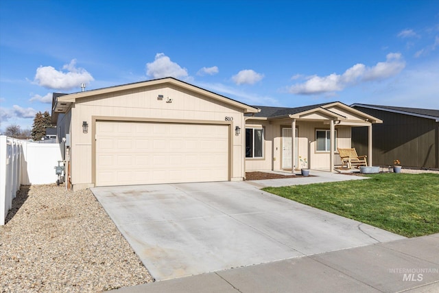 single story home with a porch, a front lawn, and a garage