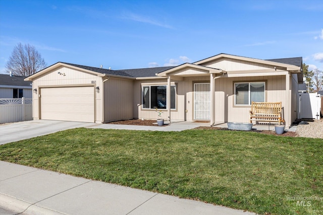 ranch-style house featuring covered porch, a front yard, and a garage