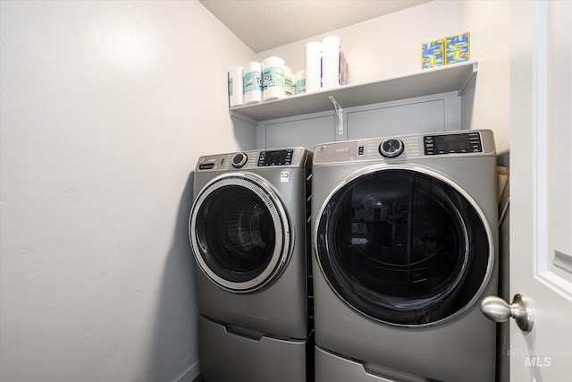 clothes washing area featuring washing machine and dryer