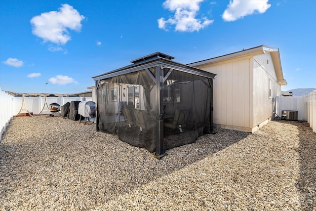 view of outdoor structure featuring central AC and a gazebo