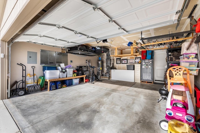 garage with electric panel, a garage door opener, and a workshop area